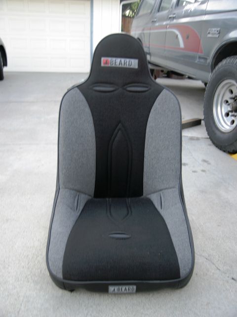 1986 Ford Bronco - A BEARD racing seat is shown in front of a vehicle.