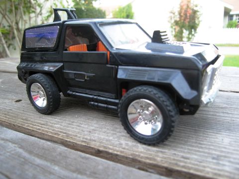 1986 Ford Bronco - This is a toy vehicle, not a 1986 Ford Bronco, with a distinctive hood scoop and side pipes.