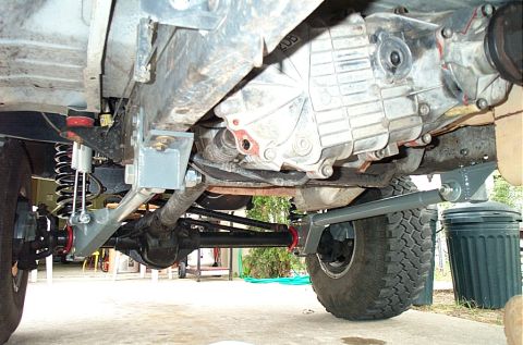 1995 Ford Bronco - Close-up view of the undercarriage, highlighting the suspension and drivetrain components of a vehicle.
