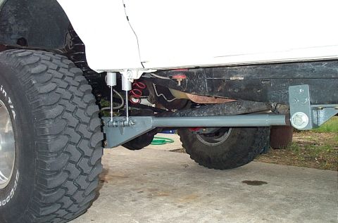 1995 Ford Bronco - Aftermarket suspension parts and a large tire are visible on a vehicle's undercarriage.