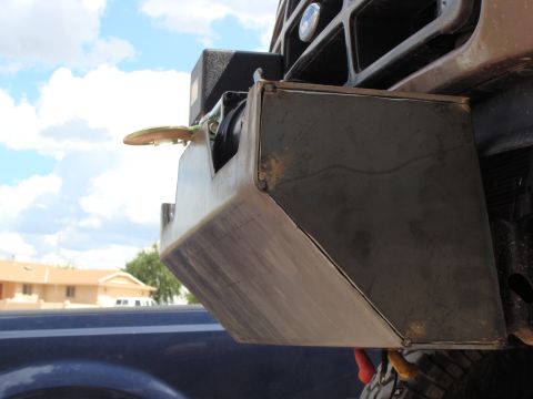 1993 Ford Bronco - Close-up of a custom-fabricated bumper with an integrated winch and tow hook, mounted on a vehicle.