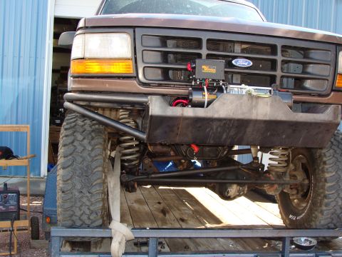 1993 Ford Bronco - Front view of a brown Ford Bronco with aftermarket modifications, including a winch and heavy-duty bumper.