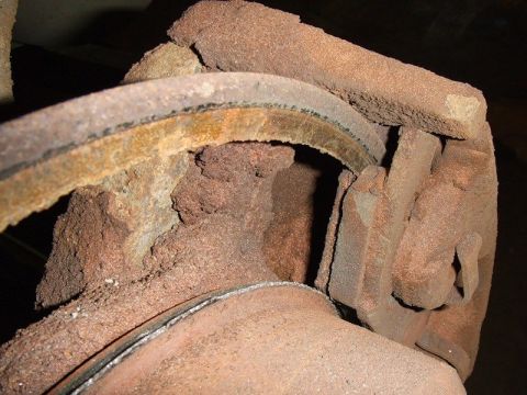 2001 Ford F-150 - Close-up view of a corroded brake system component, indicating extensive rust and damage.