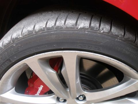 2010 Hyundai Genesis - A close-up view of a vehicle's wheel, tire, and brake caliper.