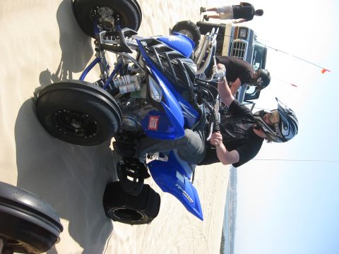 1979 Ford Bronco - Rotated (sideways) photo of a blue Yamaha Raptor sport quad on sand dunes, showing the aluminum A-arms, piggyback-reservoir front shocks an…