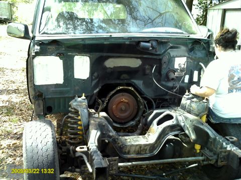 1992 Ford Bronco - The vehicle's engine bay is open, showing the chassis and suspension components.