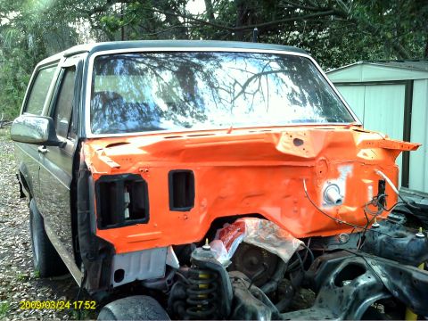 1992 Ford Bronco - This disassembled Ford Bronco, likely from the early 1980s, is undergoing restoration with its front end painted bright orange.