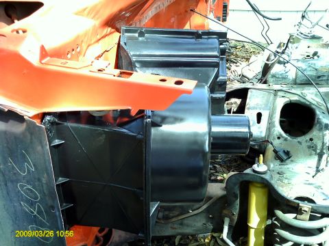 1992 Ford Bronco - This image shows a close-up view of vehicle engine bay components, including a black air intake assembly and orange structural parts.