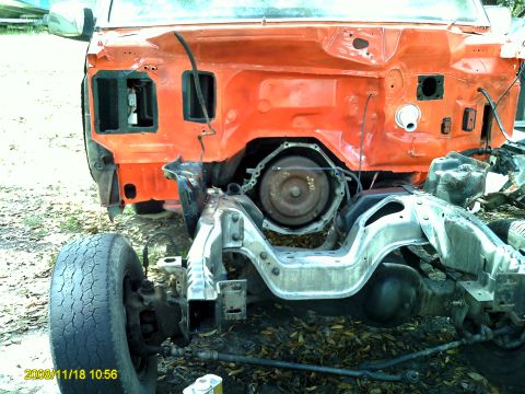 1992 Ford Bronco - This vehicle's front end is disassembled, revealing the chassis and transmission, with the front wheel and suspension visible.