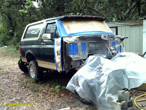 1992 Ford Bronco - This 1992 Ford Bronco is in a state of disassembly, likely for restoration, with its front end exposed and windshield taped.