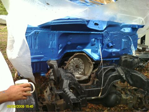 1992 Ford Bronco - A vehicle's engine bay and chassis are painted blue and partially covered with plastic sheeting.