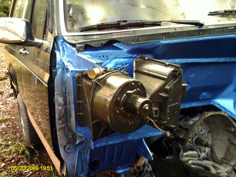 1992 Ford Bronco - The HVAC blower motor assembly is exposed in the engine bay of this vehicle, which appears to be undergoing repairs.