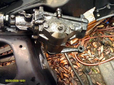 1992 Ford Bronco - Close-up of a greasy steering gear box assembly, likely from a vehicle's undercarriage.