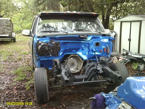 1992 Ford Bronco - This vehicle is in a state of disassembly, with the front end completely open to reveal the engine bay and chassis components.