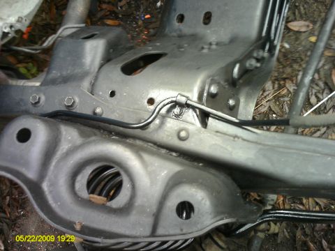 1992 Ford Bronco - Close-up view of a vehicle's frame and suspension components, showing a coil spring.