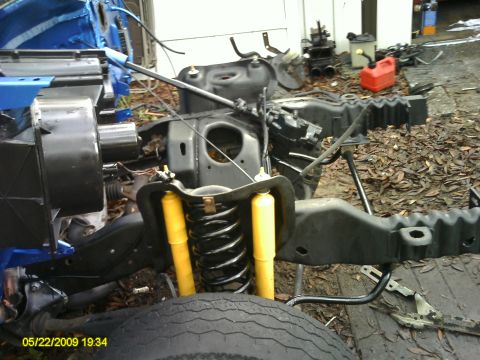 1992 Ford Bronco - The vehicle's chassis and suspension components are laid out, suggesting a restoration or repair project is underway.