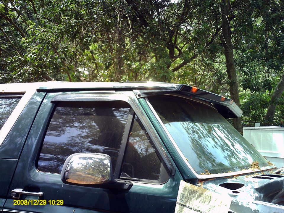 1992 Ford Bronco side view with chrome mirror and window visor