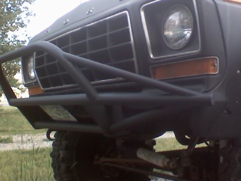 1978 Ford Bronco - The front grille and headlight assembly of a vintage Ford Bronco are visible, modified with a heavy-duty brush guard.