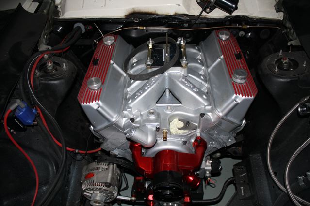 Silver V8 engine with red accents and aluminum valve covers