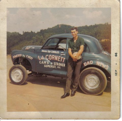 1969 MINI Cooper - A man poses with a custom drag car labeled "I.J. CORNETT CAM'S STROKER SOMERSET, NY" and "BAD NEWS" on its side.