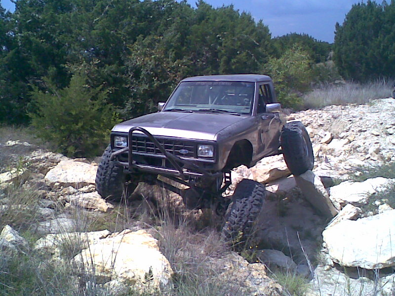 Gray 1984 Ford Bronco II on rocks with large tires