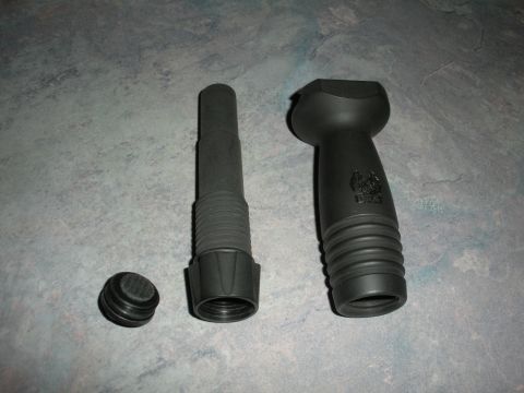 1996 Ford Bronco - Automotive funnel, cap, and a separate handle piece are laid out on a textured surface.