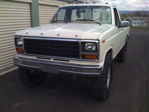 1984 Ford F-250 - This lifted white Ford F-250 truck is shown from the front, parked outdoors.