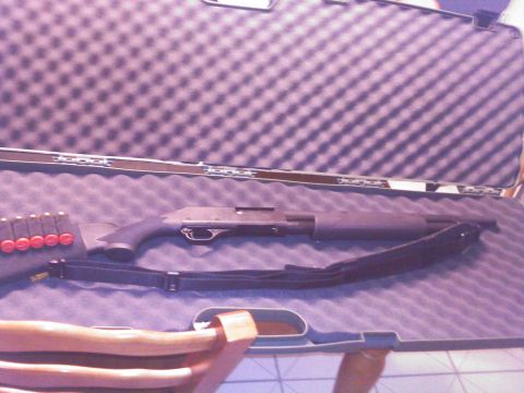 1992 Ford Bronco - A shotgun and a shell holder are neatly arranged inside a protective case.