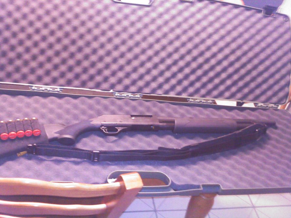 Shotgun and shells in a foam-lined case