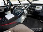1986 Ford Bronco - Interior view of a modified off-road vehicle, a custom dashboard with numerous gauges and communication equipment.