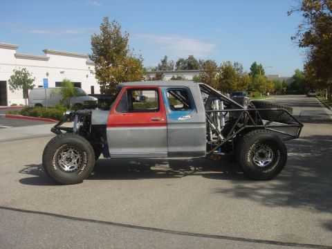 1986 Ford Bronco - This heavily modified truck features a custom roll cage and off-road tires, suggesting a build from the 1970s or early 1980s.
