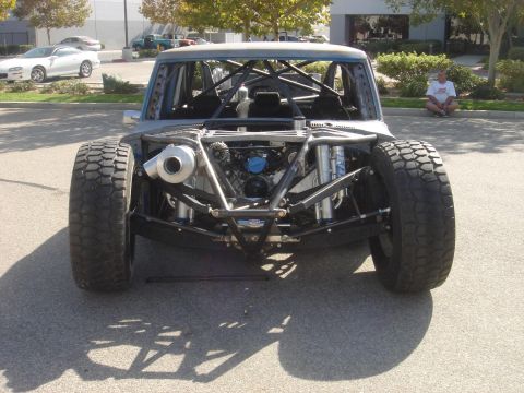 1986 Ford Bronco - This heavily modified truck features a prominent turbocharger and extensive roll cage, with its engine and suspension clearly visible from…