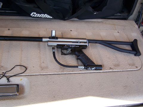1986 Ford Bronco - Spyder Elite paintball gun with black stock and barrel, connected to a CO2 tank.