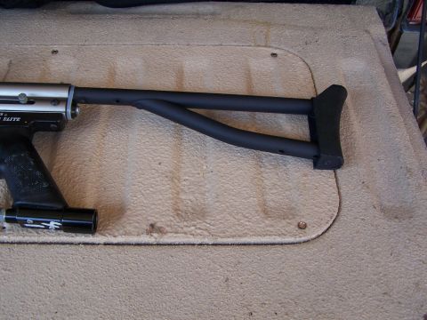 1986 Ford Bronco - A close-up view of a paintball gun's stock, resting on a textured surface.