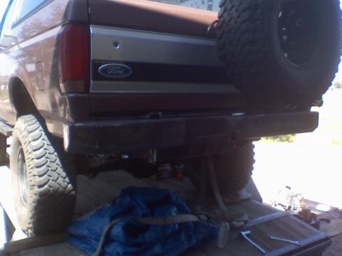 1993 Ford Bronco - The rear bumper and spare tire assembly of a 1993 Ford Bronco are visible in this image.