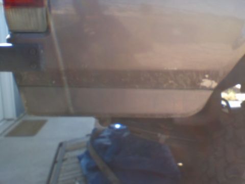1993 Ford Bronco - This photo shows a close-up view of the rear bumper and taillight of a vehicle.