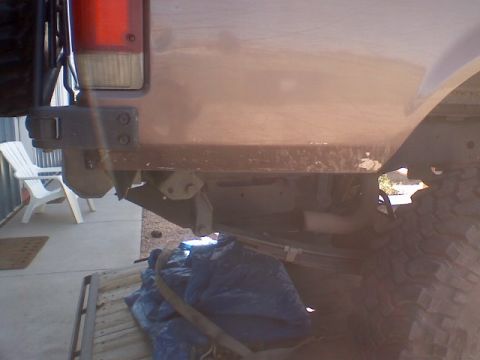 1993 Ford Bronco - The rear of a 1993 Ford Bronco shows its bumper and tire, with suspension details visible underneath.