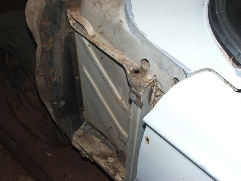 1963 Ford Fairlane - Detail of a car's undercarriage, focusing on the frame and wheel area.