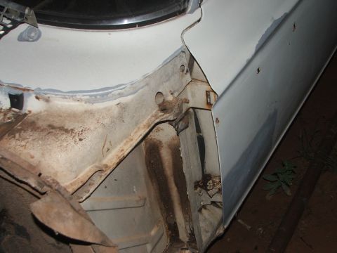 1963 Ford Fairlane - This image shows the underside of a vehicle's fender and frame, with visible rust and repair work in-progress body repairs.