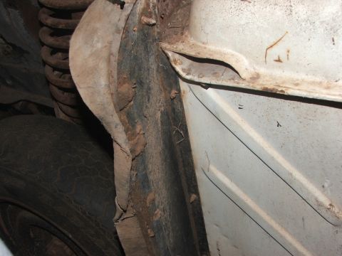 1963 Ford Fairlane - Underbody view of a 1963 Ford Fairlane, highlighting rust and a visible coil spring.