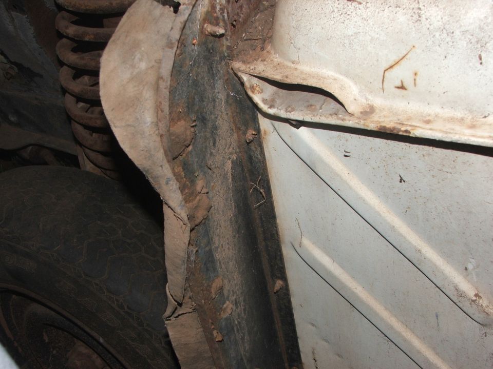 1963 Ford Fairlane underbody showing rust and coil spring