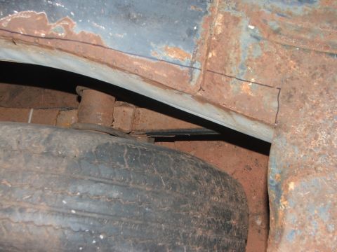 1963 Ford Fairlane - The spare tire well shows significant rust damage and is partially obscured by a tire.