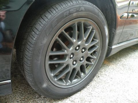 1998 Subaru Legacy - A close-up view of a car's wheel and tire, showing the tread pattern and alloy rim details.