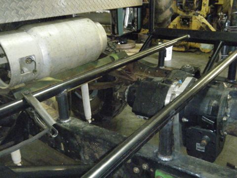 1978 Ford Bronco - Close-up view of the undercarriage, showing a large tank and complex drivetrain assembly.
