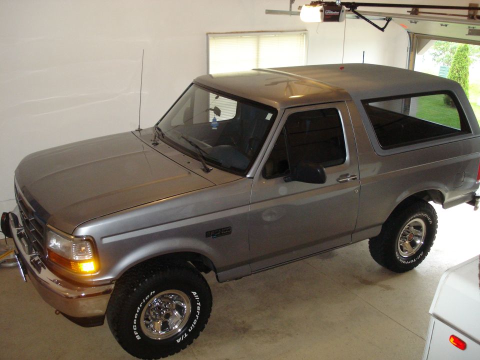Silver two-door Ford Bronco parked in a garage