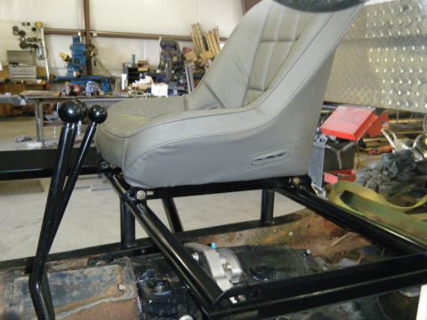 1978 Ford Bronco - Interior view of a vehicle a racing seat and dual gear shifters, with Supermotors.net branding visible.