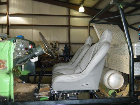 1978 Ford Bronco - Custom interior of a modified off-road vehicle, racing seats and a roll cage.