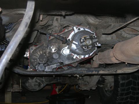 1991 Jeep Wrangler - Close-up of a vehicle's transfer case and exhaust system, likely during maintenance or modification.