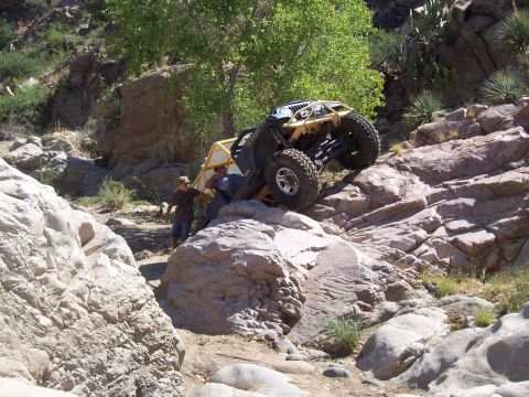 1981 Ford F-150 - An off-road vehicle navigates a rocky terrain with assistance from two individuals.