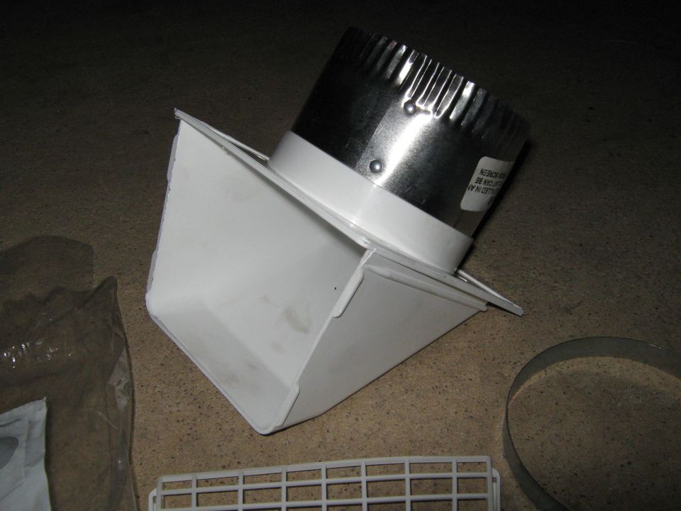 HVAC duct elbow with metal connector attached. Some text visible on connector label